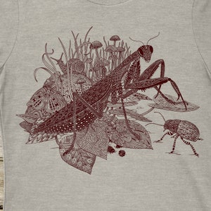 Womens cut tshirt screenprinted by hand with a detailed image of a side view of a praying mantis looking at your. Surrounded by a beetle, snail, mother and pill bugs. Available on Cream and Heather Gray shirts.