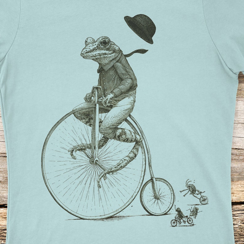 Frog riding a penny farthing bicycle