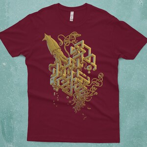 A giant squid surrounded by an impossible structure, reminiscent of M.C. Escher. Screen printed on a cranberry red, Next Level T-shirt by Scatterbrain Tees