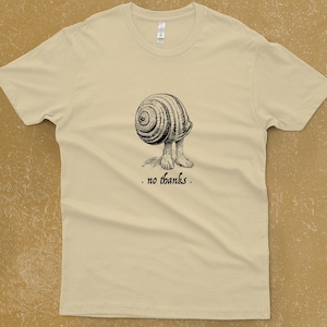 A Snail shell with human feet sticking out of the bottom. The caption reads "no thanks". It's printed with black ink on a cream shirt. No Thanks Shirt - Introvert T-shirt - Funny Shirts For Men - Not Today Sassy Tee - Get Out of Your Shell - Funny Men's Clothing