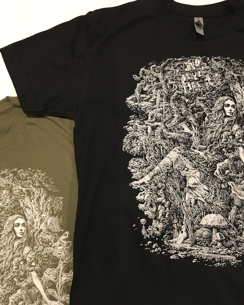A Black mens tshirt with an image of a woman with long hair covered in twisting branches and mushrooms. Titled Mother Natures Daughter.