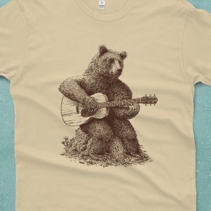 Men's bear shirt. The bear is sitting on a log playing a guitar.