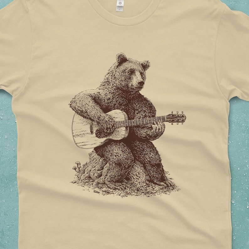 Men's bear shirt. The bear is sitting on a log playing a guitar.