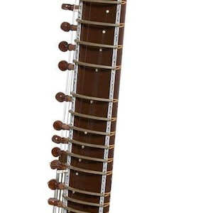 May include: A brown sitar, a plucked stringed instrument, with intricate carvings and decorative silver accents. The instrument features a long neck with frets and tuning pegs, and a rounded resonating gourd.