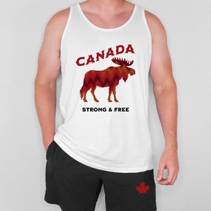 May include: White tank top with a red moose graphic and the word "CANADA" above it. Below the moose is the text "STRONG & FREE". The person is also wearing black shorts with a red maple leaf.