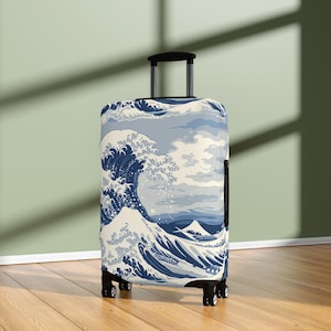 May include: A rolling suitcase featuring a blue and white print of Hokusai's "The Great Wave off Kanagawa." The design includes a large wave, Mount Fuji, and a blue and white color scheme. The suitcase has a black handle and wheels.