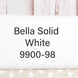 May include: White fabric swatch with the text "Bella Solid White 9900-98" printed on it.
