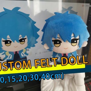 May include: A plush doll with bright blue hair, large dark eyes, and a light complexion, wearing a blue and black jacket. The doll is displayed in front of a computer screen showing a matching digital illustration with the text CUSTOM FELT DOLL (10,15,20,30,40cm).