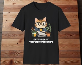 May include: Black t-shirt with a cartoon cat wearing glasses and holding a stack of papers. The text "Cat Therapy The Purrfect Solution!" is printed below the cat.