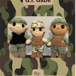 May include: Three crocheted dolls in military-style outfits, each with a unique camouflage pattern. The dolls have tan skin, black eyes, and wear hats and vests. The text "G.I. Gabe" and "By: Nathan - VV's Stitches" are displayed.