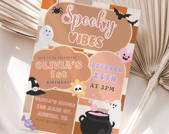 May include: A Halloween-themed invitation card with the words "Spooky Vibes". The invitation includes details for Olivia's 1st birthday on October 25th at 3 PM, with a witch's hat, ghosts, and a cauldron.
