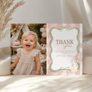 May include: A thank you card featuring a photo of a smiling child in a cream dress on the left and a pink gingham background on the right. The text reads: THANK you, I loved the cake and the presents too, but the best part was seeing you! with love, Olivia.