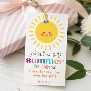 May include: A white gift tag with a yellow sun illustration and the text "school is out summer is here thanks for all you've done this year!" The tag is tied with twine and is next to a pink striped gift box.