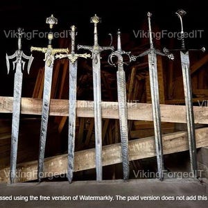 May include: An assortment of six ornate swords with intricate designs. The blades are silver, and the handles feature gold and black accents. The swords are displayed against a wooden backdrop, showcasing their craftsmanship.