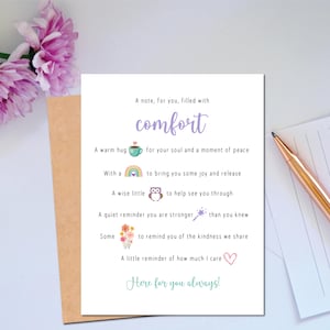 May include: A white greeting card featuring the text A note, for you, filled with comfort, followed by lines with icons including a teal coffee cup, a rainbow, an owl, a purple star wand, a bouquet of flowers, and a pink heart, ending with Here for you always!