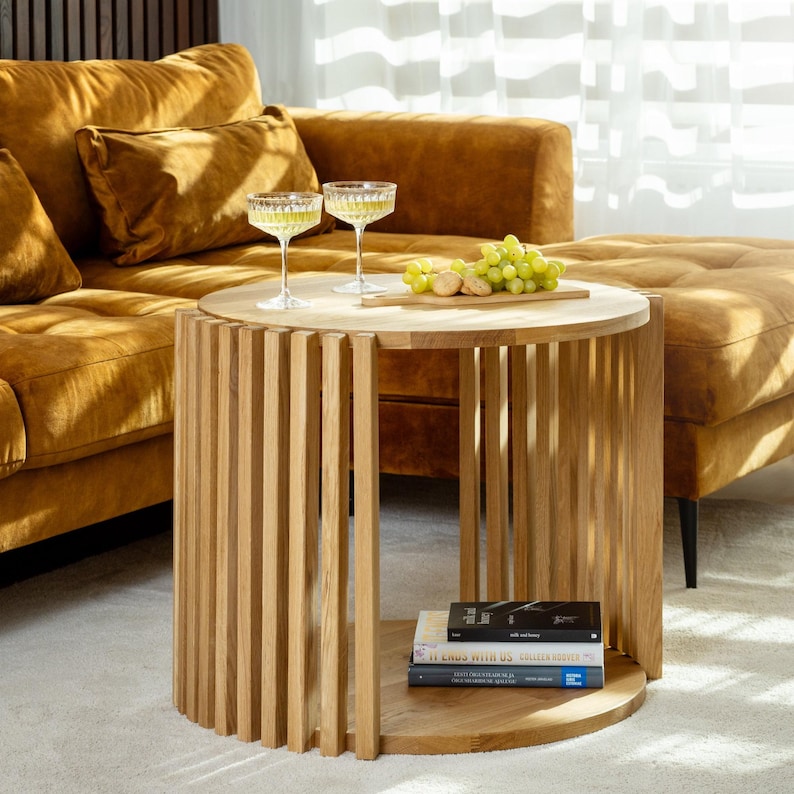Natural solid oak fluted round coffee table. Coffee table is 2-tiered Japandi style that fits perfectly for scandinavian interiors, modern or mid century modern interious.