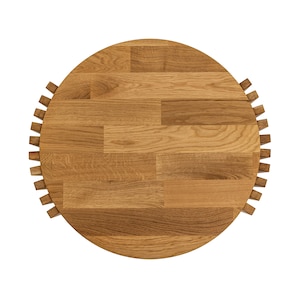 May include: A round wooden table top with a unique design. The top is made of light brown wood and has a circular pattern of small squares.