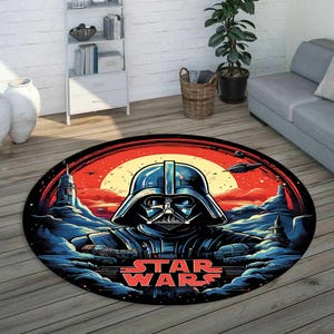 May include: Oval Star Wars area rug featuring Darth Vader's helmet against a red and yellow sunset backdrop. The rug has a black border and the words "STAR WARS" in red. The design includes illustrations of spaceships and a futuristic landscape.