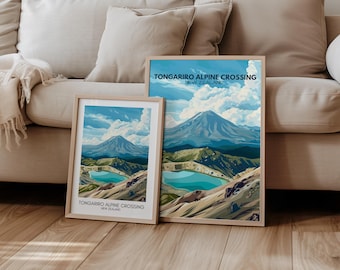 May include: Two framed illustrations of the Tongariro Alpine Crossing in New Zealand. The top illustration shows a mountain range with a blue lake in the foreground. The bottom illustration shows a closer view of the lake and surrounding mountains.