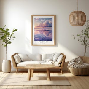 May include: A framed print of a landscape photograph of a salt flat in Bolivia. The photo shows a large, fluffy cloud reflected in the water. The text "SALAR DE UYUNI, BOLIVIA" is printed below the image.