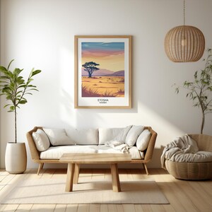 May include: A framed print of a landscape scene with a single tree in the foreground and a sunset sky in the background. The print is titled "Etosha, Namibia".
