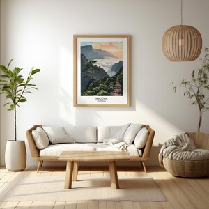 May include: A framed print of a scenic landscape in Madeira, Portugal. The image shows a mountain path winding through a lush green valley with clouds in the background. The text "Madeira, Portugal" is printed below the image.