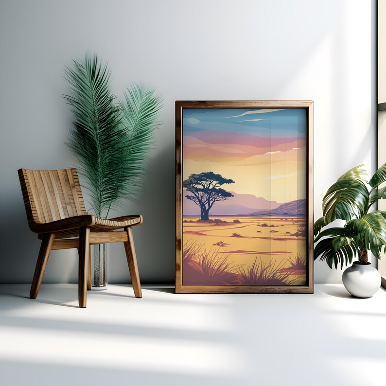 May include: A framed print of a sunset landscape with a single tree in the foreground. The sky is a gradient of pink, orange, and yellow, and the ground is a sandy brown.