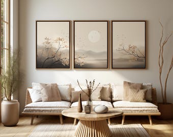 May include: A living room scene featuring a light-colored sofa with multiple pillows, a wooden coffee table, and three framed landscape paintings. The paintings depict a serene landscape with a soft color palette of beige, brown, and gray.