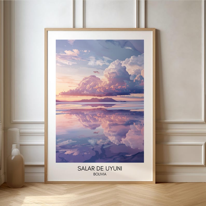 May include: A framed print of a landscape photograph of a salt flat in Bolivia. The sky is a vibrant pink and purple with fluffy white clouds reflected in the water. The text "SALAR DE UYUNI" and "BOLIVIA" is printed at the bottom of the image.