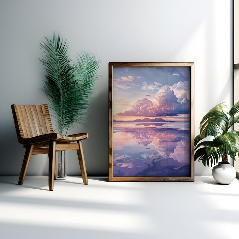 May include: A framed print of a landscape with a large, fluffy cloud reflecting in a still body of water. The sky is a soft pink and purple, and the water is a light blue. The frame is a dark brown wood.