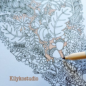 May include: A black and white intricate line drawing of a floral design with leaves, flowers, and pumpkins. The design is partially colored in with a light peach color. The word "Kilykostudio" is written in brown text at the bottom of the image.