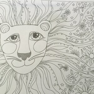 May include: A black and white line drawing of a lion's face with a flowing mane. The mane is filled with intricate patterns of swirls, dots, and stars. The lion's face is simple and sweet with large eyes and a small nose.