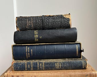 May include: A stack of vintage books with leather and blue cloth covers. The titles include "Manual of the Crucifixion", "Common Prayer Hymn Book", "Science and Health", "With Key to the Scriptures", and "Know Your Bible?".