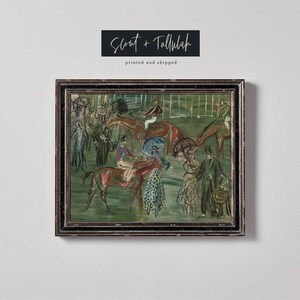 May include: A framed print of an impressionistic painting depicting a horse race scene. The artwork features horses, jockeys, and spectators in a green and brown color palette. The frame is dark with a textured design. The text "Scout + Tallulah" is at the top.