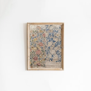 May include: A framed print of a vintage floral design with blue, pink, and yellow flowers and birds. The print is in a light wood frame.