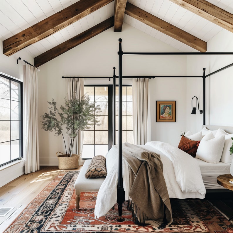 May include: A white canopy bed with a black metal frame and a brown throw blanket. The bed is in a bedroom with a wooden ceiling and large windows.