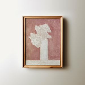 May include: A framed painting of a white flower arrangement in a white vase against a pink background.