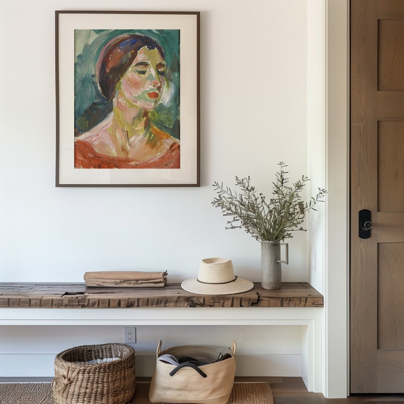 May include: A wooden bench with a white shelf and a framed painting of a woman with a red hat. There is a straw hat, a wicker basket, and a canvas tote bag on the shelf. A vase with green branches sits on the bench.