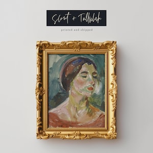 May include: A framed painting of a woman's portrait. The woman is wearing a light blue hat and a red shirt. The painting is in a gold frame with ornate details.