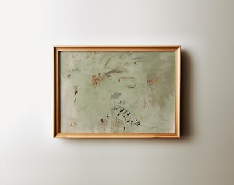 May include: Abstract artwork in a light wooden frame. The painting features a muted green background with brushstrokes of brown, black, and blue. The artwork is mounted on a white wall.