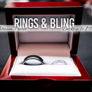 May include: Two wedding bands in a red velvet ring box. The bands are silver and black with a diamond pattern. The box has the text "Rings & Bling Lightroom Preset Desktop & Mobile" on the top.