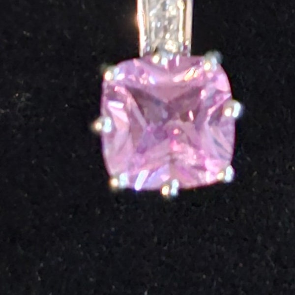 Vintage sterling silver pendant with a pink cubic zirconia stone.