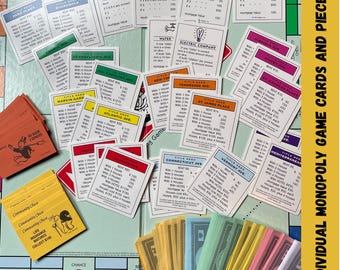 May include: A selection of individual Monopoly game cards and pieces, including property deeds, chance cards, and community chest cards. The cards are arranged on a game board, with the text "Pick and Choose" at the bottom.