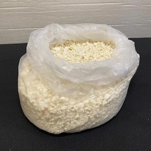 May include: A white plastic bag filled with white packing peanuts.