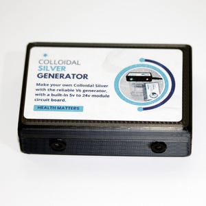 May include: A black colloidal silver generator with a white label. The label has the text "COLLOIDAL SILVER GENERATOR" and "HEALTH MATTERS". The generator is designed to make colloidal silver with a built-in 5v to 24v module circuit board.