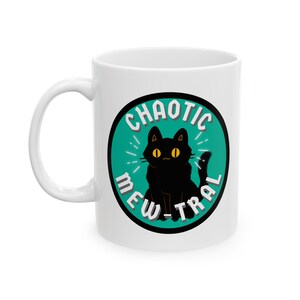 May include: White ceramic mug with a black cat illustration and the text "CHAOTIC MEW-TRAL" in a teal circle.