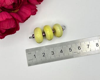 Pair of banana yellow donut shaped artsy lampwork glass beads for jewelry making