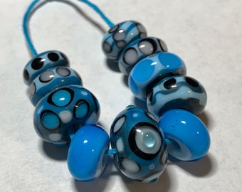 Set of 10 handmade lampwork glass beads in opaque dark turquoise, transparent light blue, black, white and pastel pink.