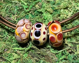 Set of three earth tone, handmade lampwork glass beads in copper, ivory, black, and lots of clear