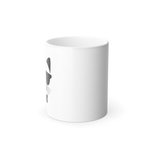 May include: White ceramic mug with a minimalist raccoon design in grey tones. The raccoon's face is illustrated with simple lines and shapes, including a mask, whiskers, and a small nose. The mug is cylindrical and has a handle.